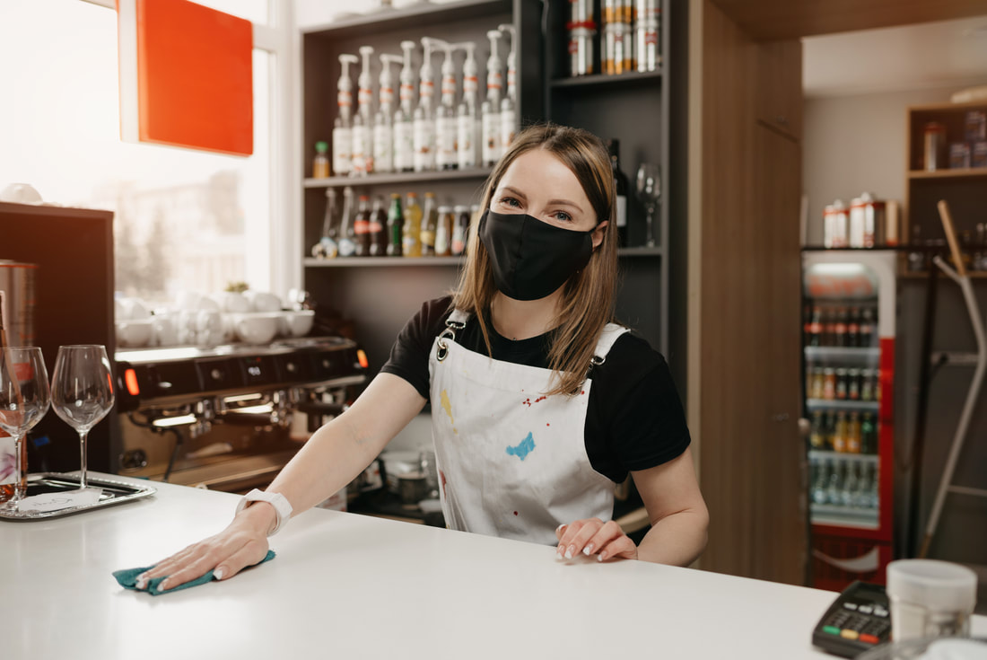 Cashier Cleaning Counter with Mask